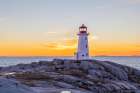 Peggys Cove Lighthouse in winter at sunset, Nova Scotia, Canada. Art Print